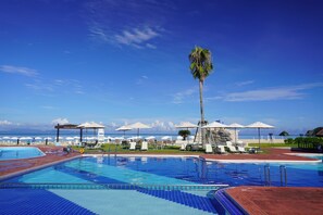 Seasonal outdoor pool, open 9:00 AM to 6:00 PM, pool umbrellas