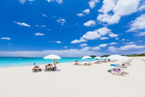 A beach with white umbrellas and sun loungers. - Okuma Private Beach & Resort (Kunigami)