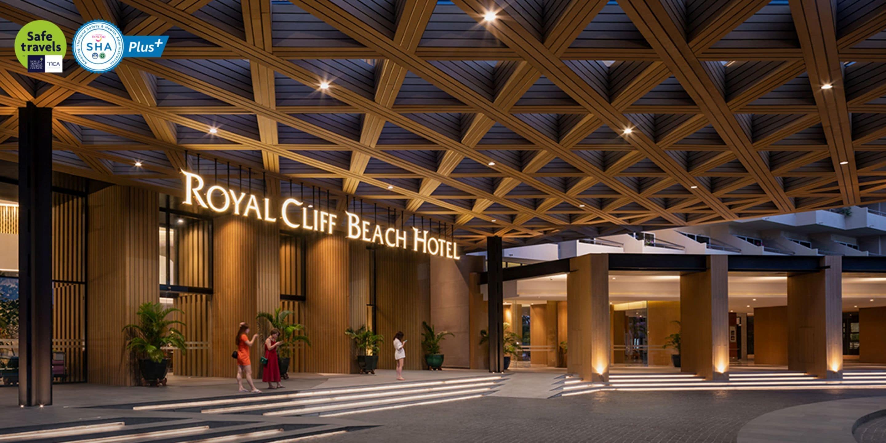The exterior of the Royal Cliff Beach Hotel with a modern architectural design, featuring a prominent entrance and a well-lit facade.