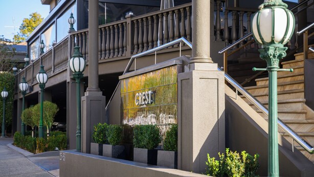 A building with a sign reading "Crest" and a staircase leading to an upper level. - Crest on Barkly (St Kilda)
