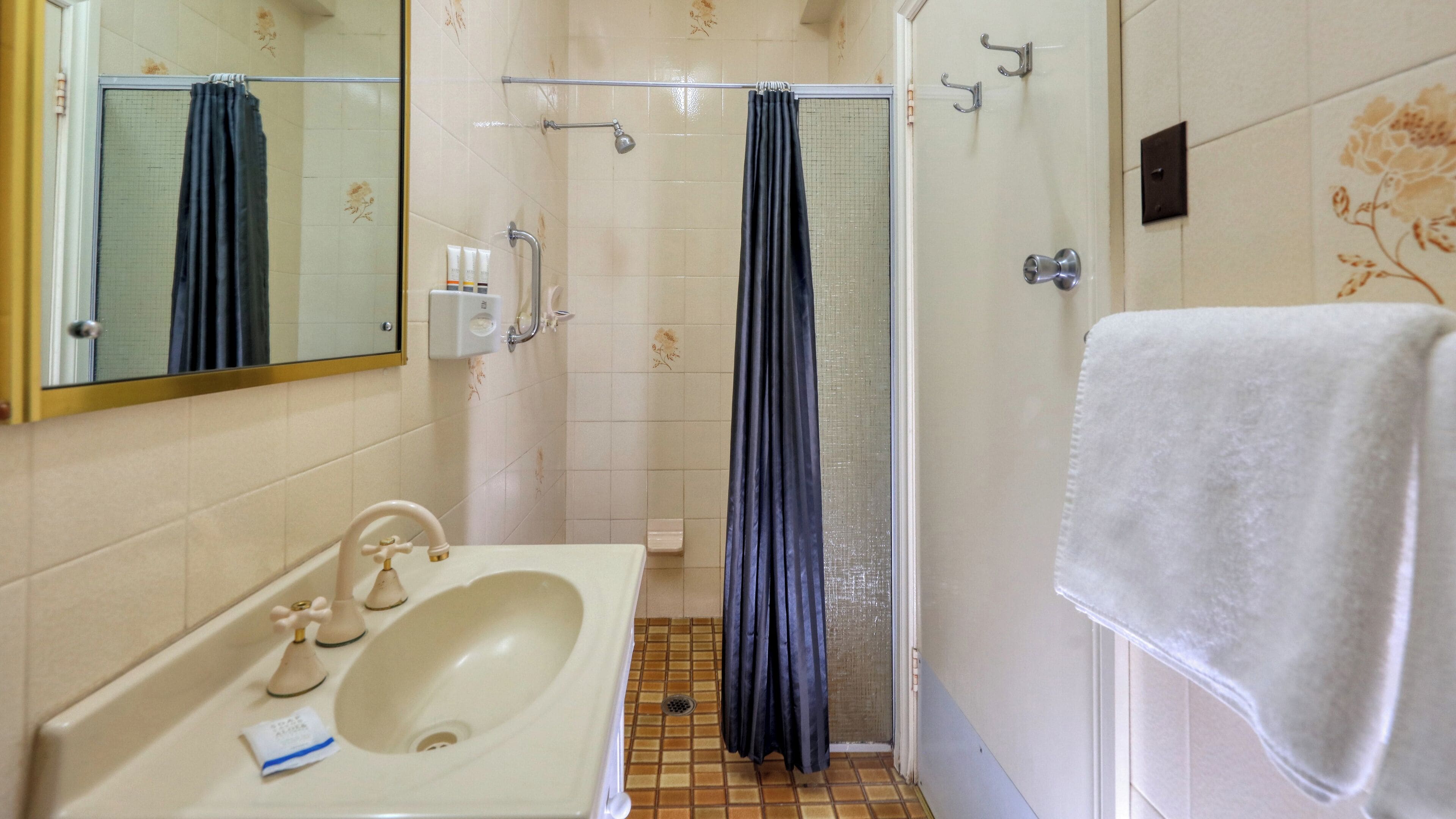 shower, rainfall showerhead, hair dryer, towels