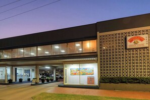 A building with a sign for "Golden Lotus Chinese Cuisine" and a large window display. - Comfort Inn Crystal (Broken Hill)