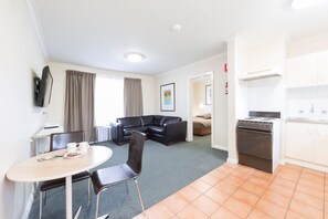 Standard One Bedroom Apartment | Living area | 30-inch flat-screen TV with cable channels, TV