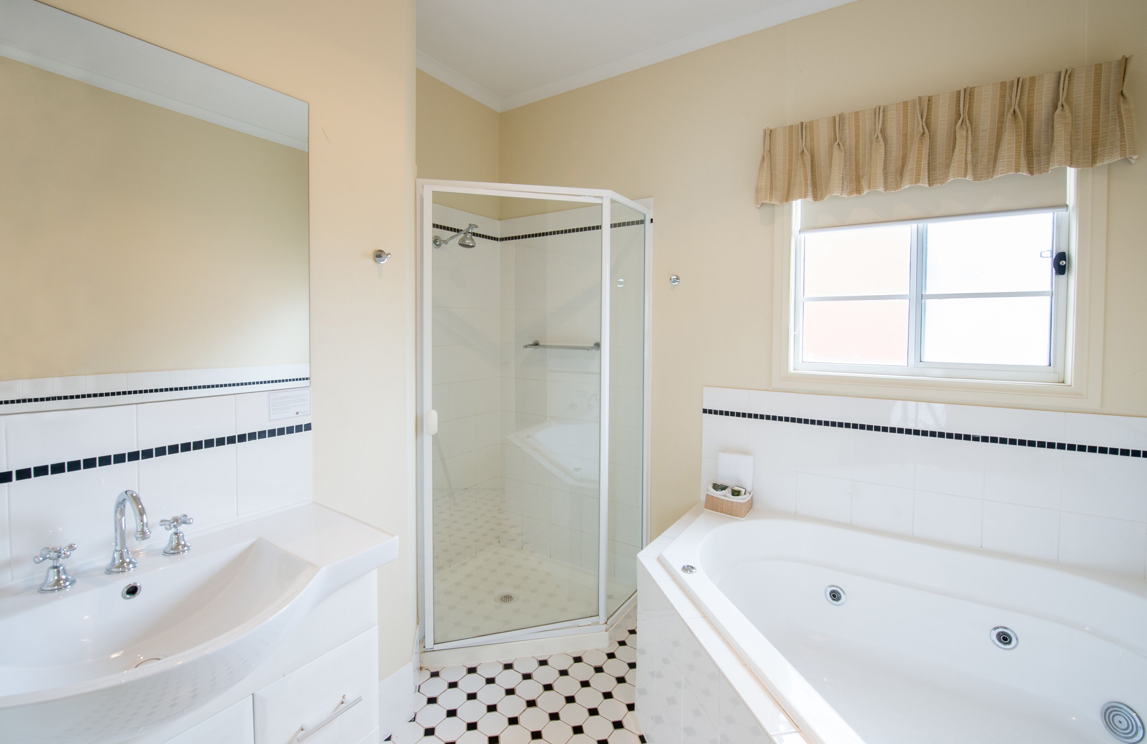 A bathroom with a shower, a sink, and a bathtub.