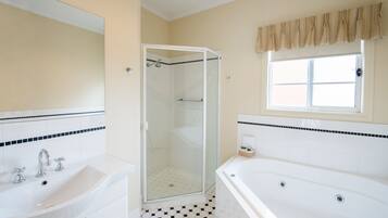 A bathroom with a shower, a sink, and a bathtub.