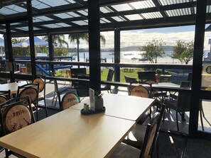 Dine al fresco with a view of the water and distant mountains.