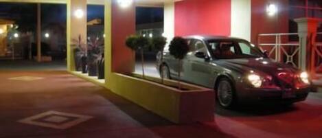 A modern building with a car parked in front.