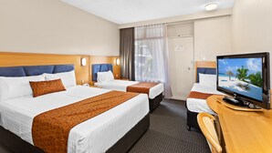 A hotel room with two beds, a desk with a television, and a window with curtains. - Park Motor Inn (East Toowoomba)