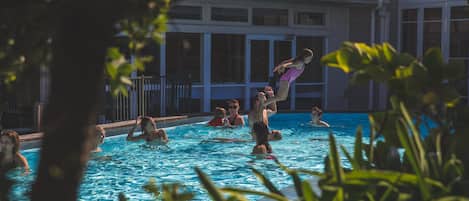 A swimming pool with people enjoying the water.