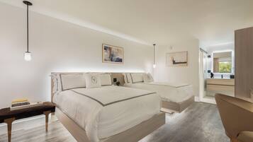A modern bedroom with a large bed, bedside tables, and a desk.