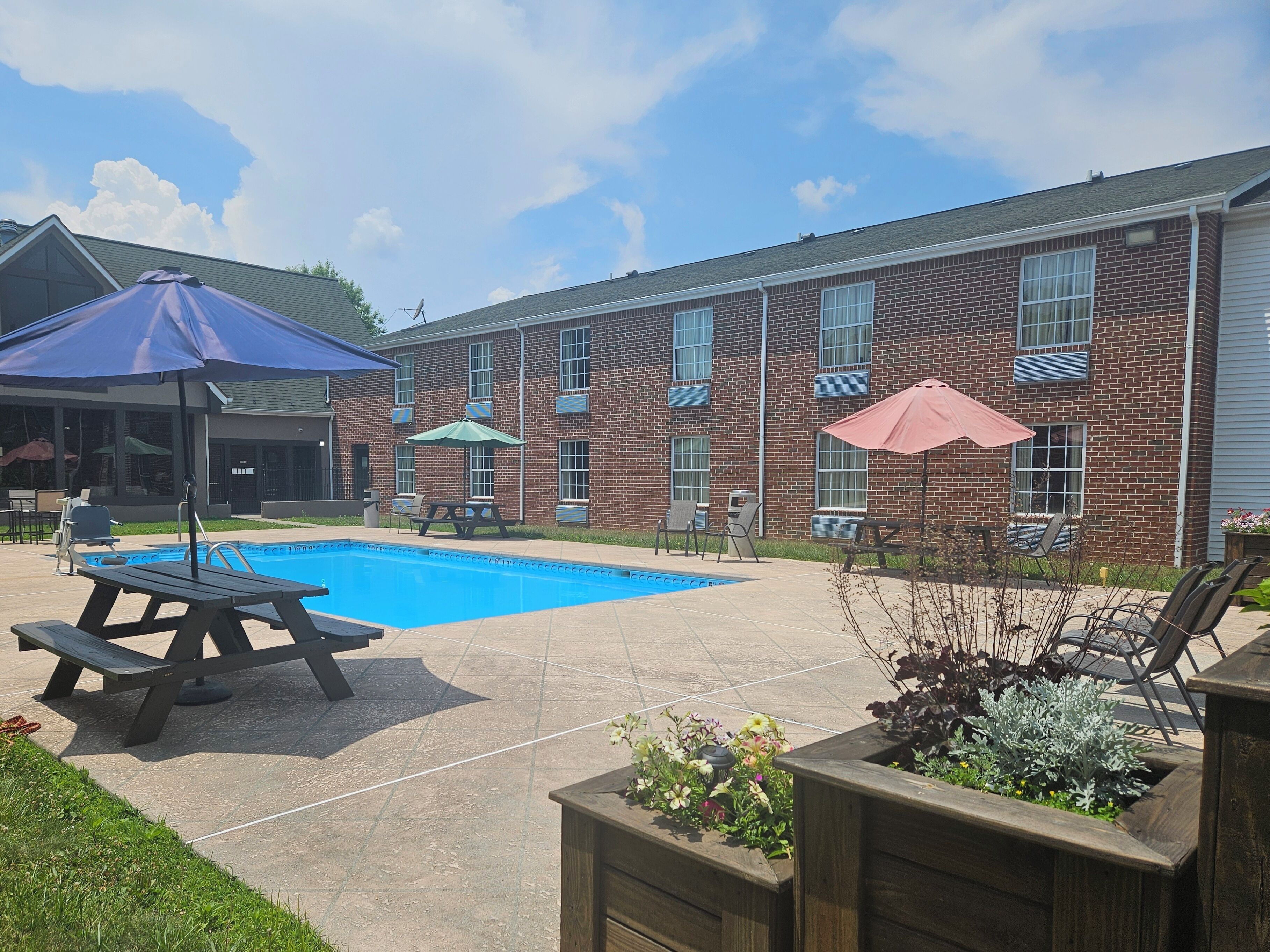 Seasonal outdoor pool, open 9:00 AM to 9:00 PM, pool umbrellas