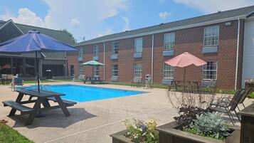 Seasonal outdoor pool, open 9:00 AM to 9:00 PM, pool umbrellas