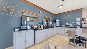 A modern kitchen with a built-in coffee station, microwave, and various food items. - Best Western Regency Inn & Suites (Gonzales)