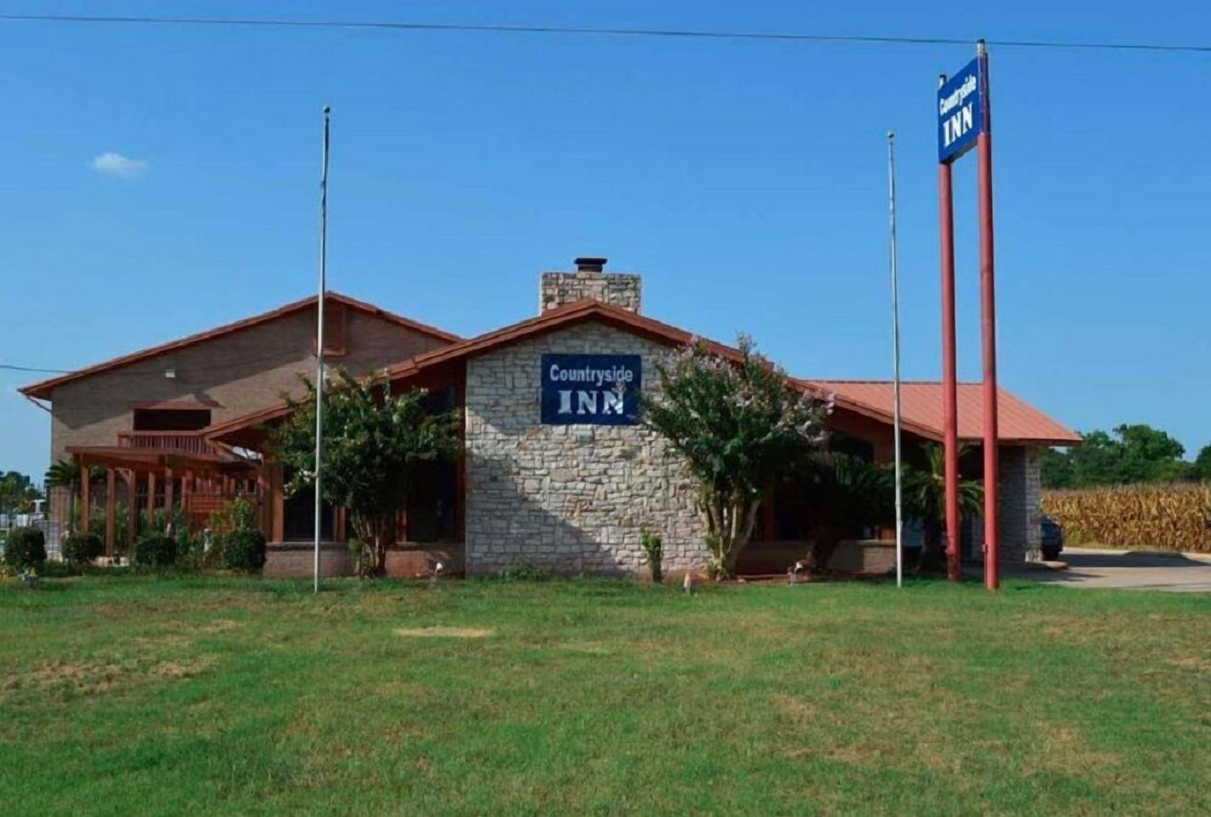 A building with a stone facade and a sign reading "Countryside Inn".