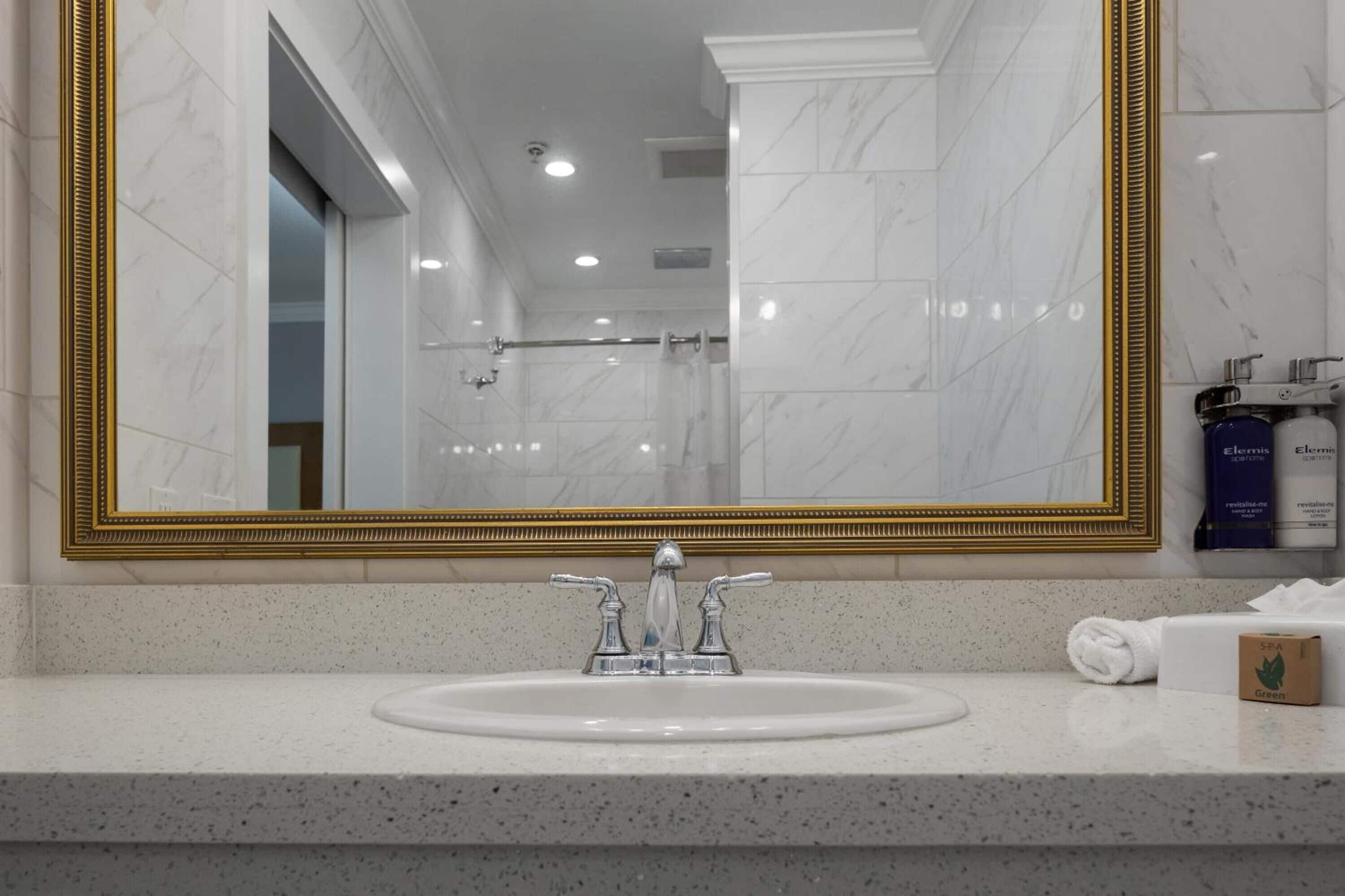 combined shower/bathtub, designer toiletries, hair dryer, towels