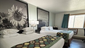 A hotel room with two beds, a large wall mural, a window with curtains, and a wall-mounted air conditioning unit. - Super 8 by Wyndham West Fargo Main Ave ND (West Fargo)
