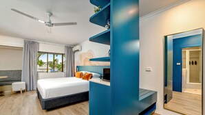 A modern hotel room with a bed, a desk, a ceiling fan, and a large window. - Mercure Cairns (Cairns)