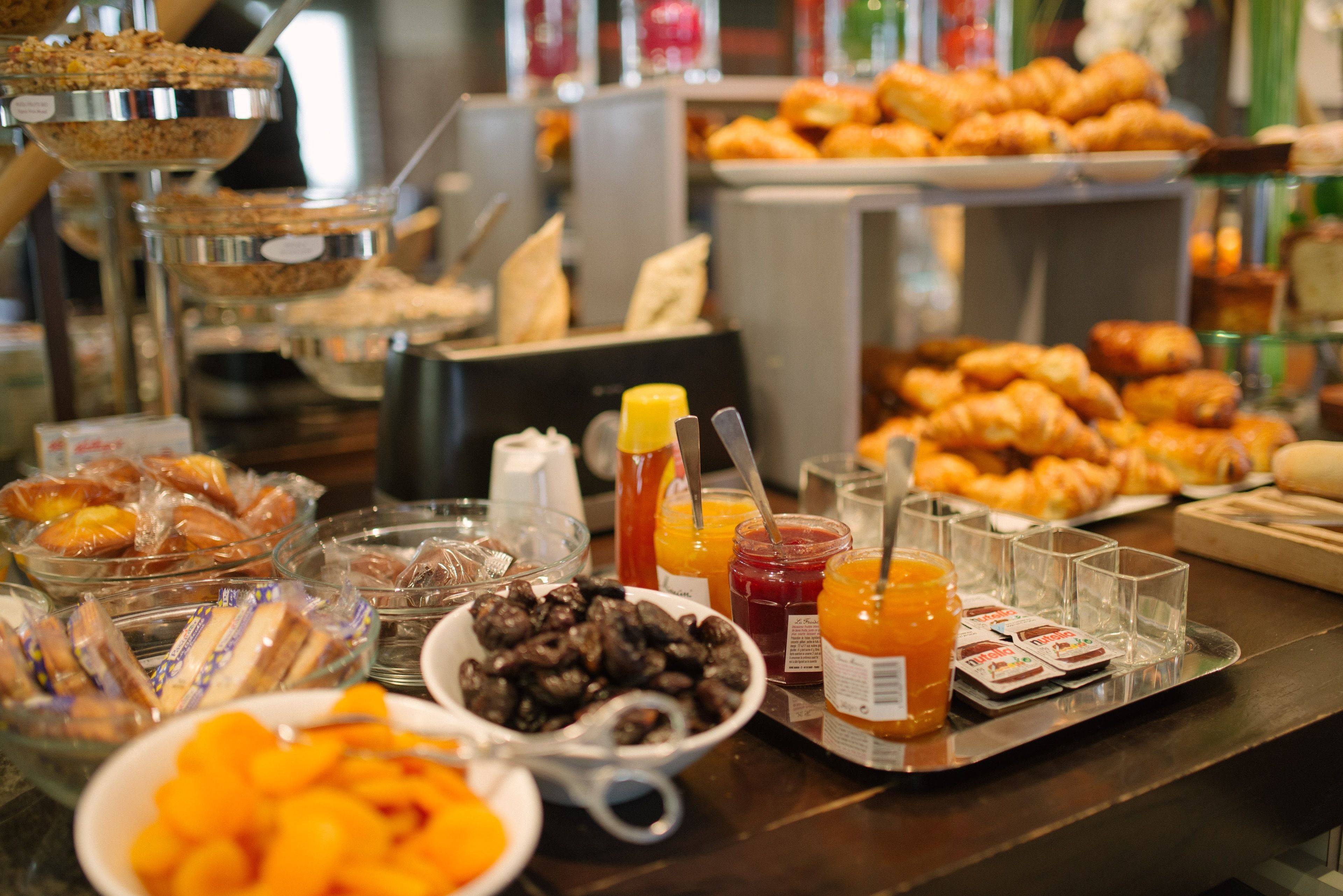 Een buffet met diverse gerechten, waaronder fruit, gebak en dranken.