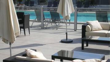 Seasonal outdoor pool, open 7:00 AM to 10:30 PM, pool loungers