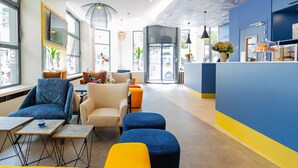 A modern hotel lobby with seating areas, a reception desk, and decorative ceiling lights. - Best Western Mulhouse Salvator Centre (Mulhouse)