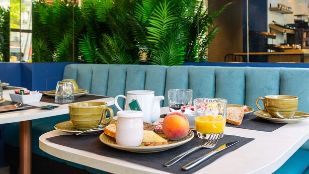 A breakfast setting with a plate of food, a jug, a cup, and a glass of orange juice. - Best Western Mulhouse Salvator Centre (Mulhouse)