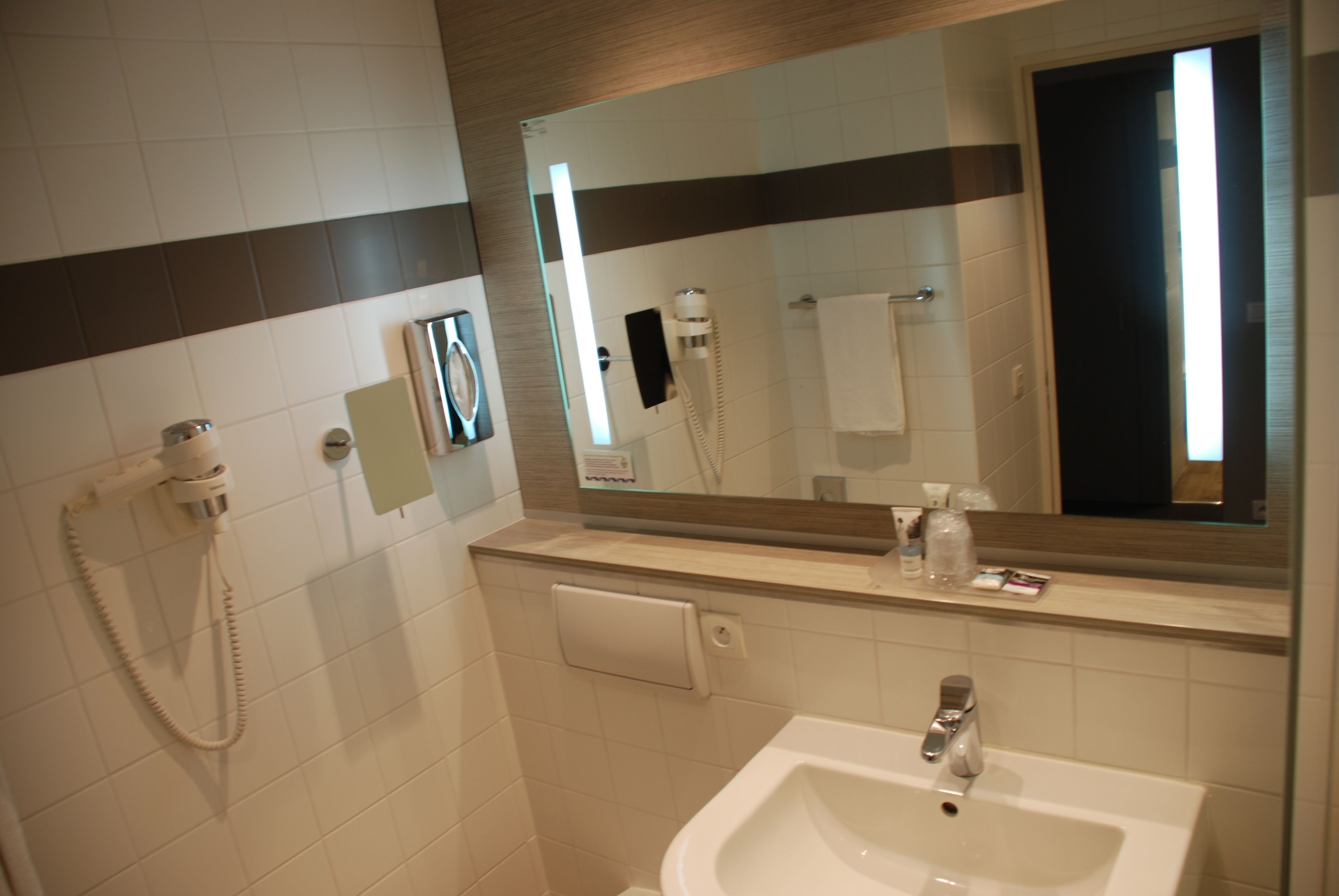 eco-friendly toiletries, hair dryer, towels, toilet paper