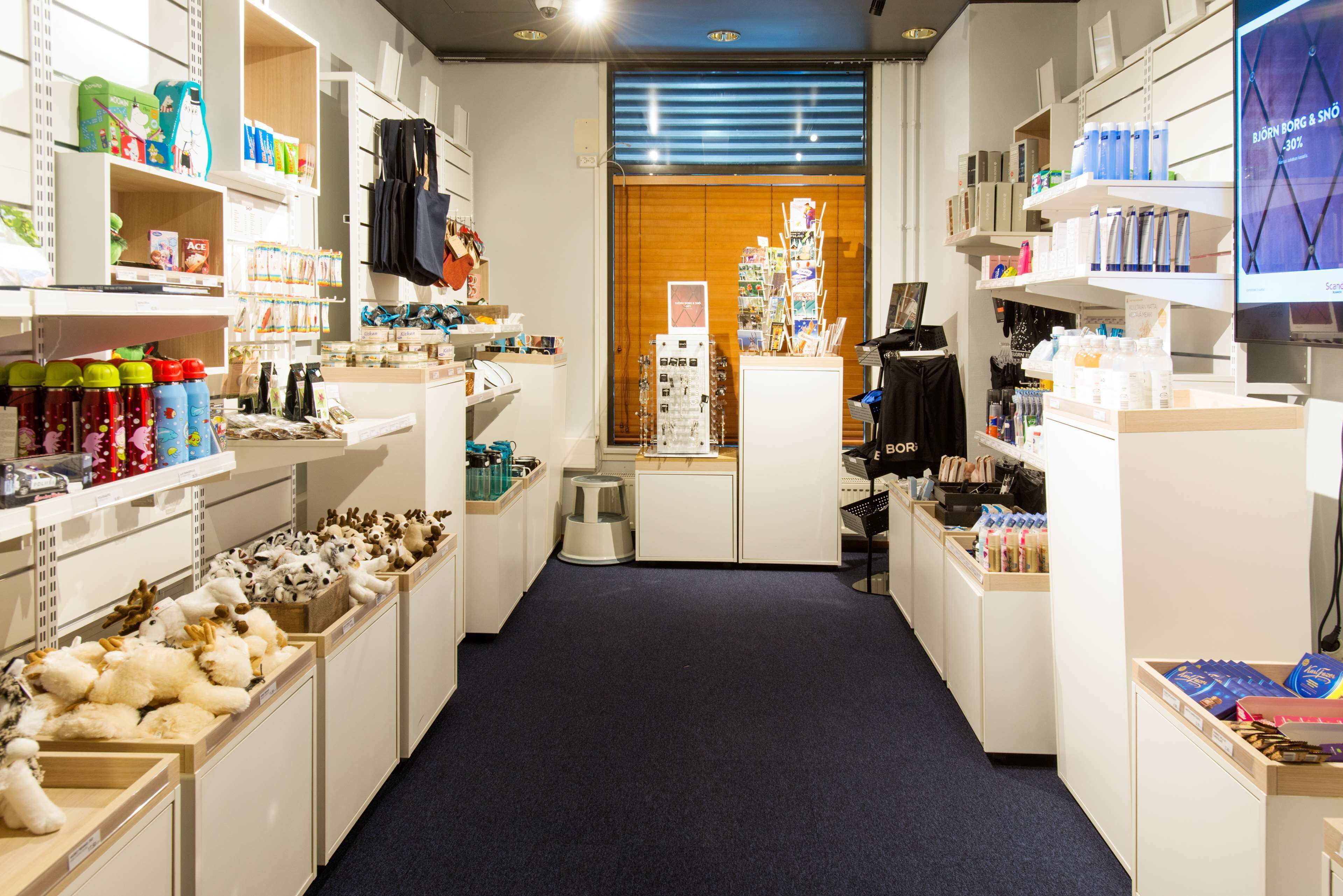 A store with shelves stocked with various items, including bottles and boxes.