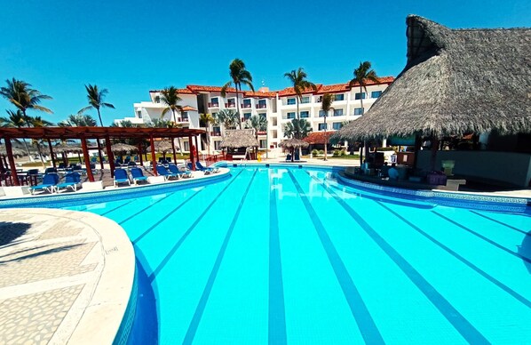 Outdoor pool, open 9:00 AM to 7:00 PM, pool umbrellas