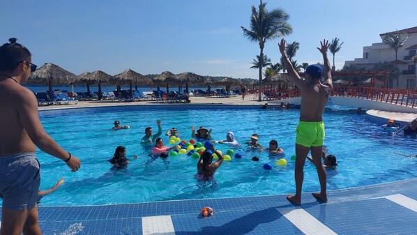 Outdoor pool, open 9:00 AM to 7:00 PM, pool umbrellas