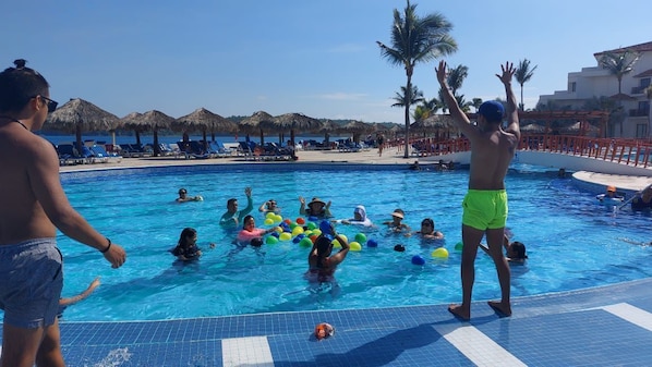 Outdoor pool, open 9:00 AM to 7:00 PM, pool umbrellas