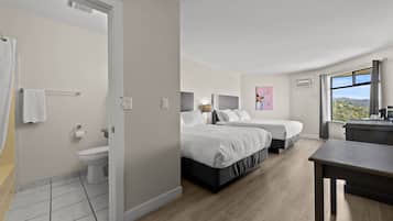 Et moderne hotelværelse med to senge, et badeværelse og udsigt til det fri.