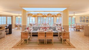 A spacious dining area with a high ceiling, large windows, and a piano. - Gateway Coonoor (Coonoor)