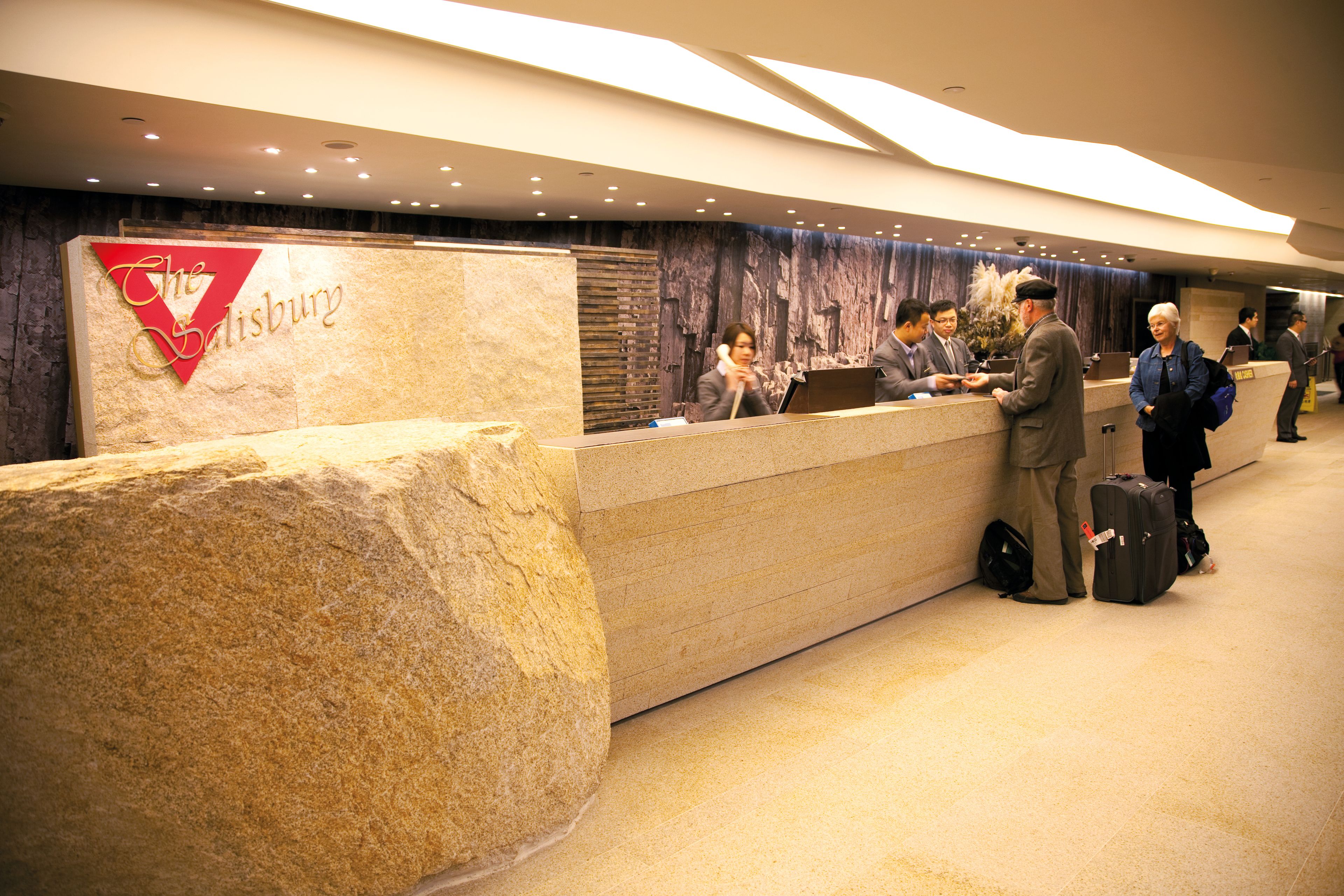 A reception desk with a stone base and a sign reading "The Salisbury."
