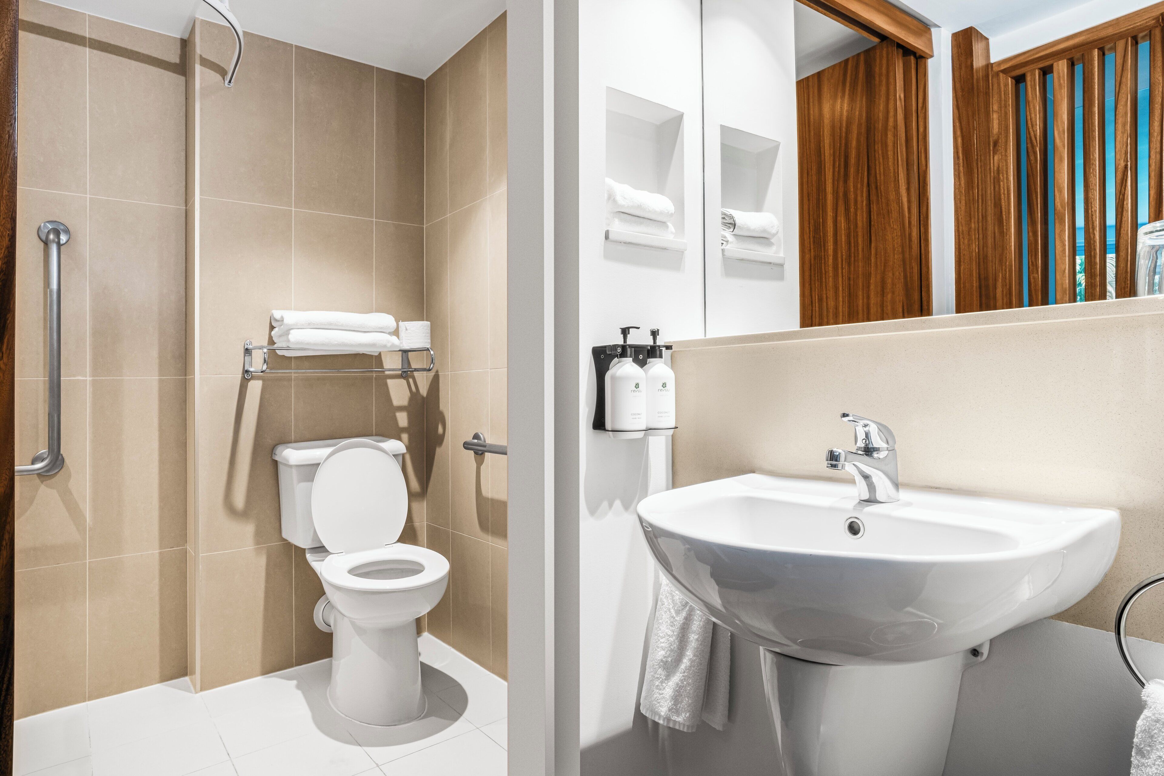 Un baño moderno con inodoro, ducha y lavamanos.