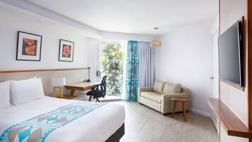 A hotel room with a bed, a desk, a chair, a sofa, a TV, and a balcony with curtains.