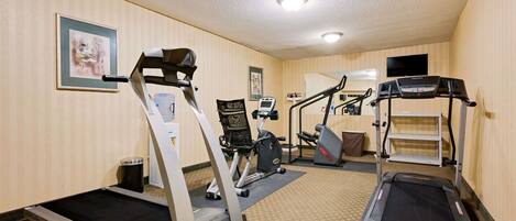Ett hotells gym med löpband, crosstrainers och en trappmaskin.
