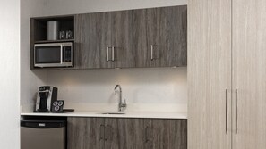 A modern kitchen with a built-in microwave, coffee maker, and dishwasher. - Holiday Inn Express Quebec City - Sainte Foy by IHG (Québec City)