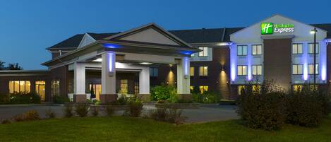 A Holiday Inn Express hotel with a covered entrance, brick facade, and illuminated signage.