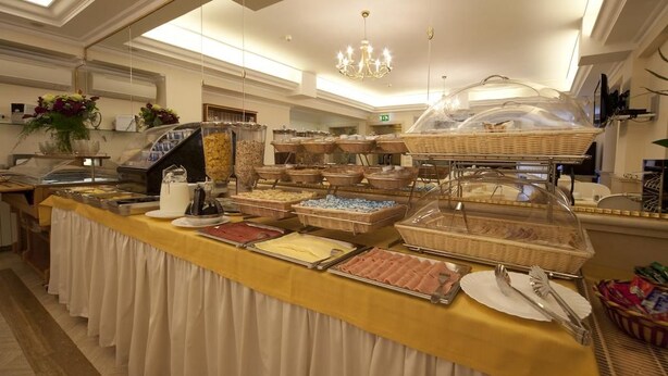 A buffet setup with various food items and a buffet line. - Galileo (Rome)