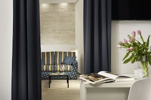 Superior Triple Room | Living area | 19-inch flat-screen TV with cable channels, TV