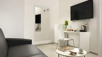 Superior Triple Room | Living area | 19-inch flat-screen TV with cable channels, TV
