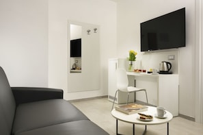 Superior Triple Room | Living area | 19-inch flat-screen TV with cable channels, TV