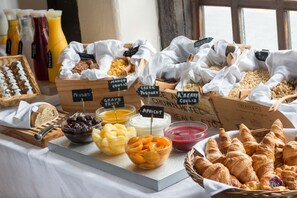A breakfast buffet with various fruits, yogurts, and pastries. - Best Western The Rose & Crown Hotel (Colchester)