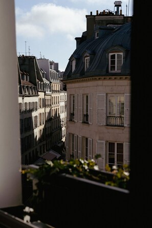 A view of multi-story buildings with balconies and shutters, suggesting a European urban setting. - Hôtel de Buci (Paris)