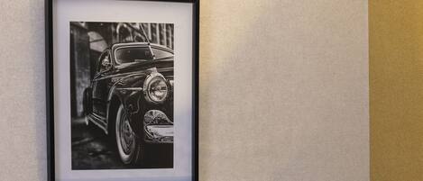 A framed black and white photograph of a vintage car.
