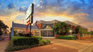 A modern motel with a prominent sign, a parking area, and a landscaped entrance. - Dubbo RSL Club Motel (Dubbo)