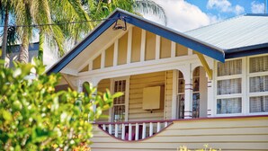 A two-story house with a porch, a visible attic window, and a metal roof. - Fitzroy Motor Inn Grafton (Grafton)