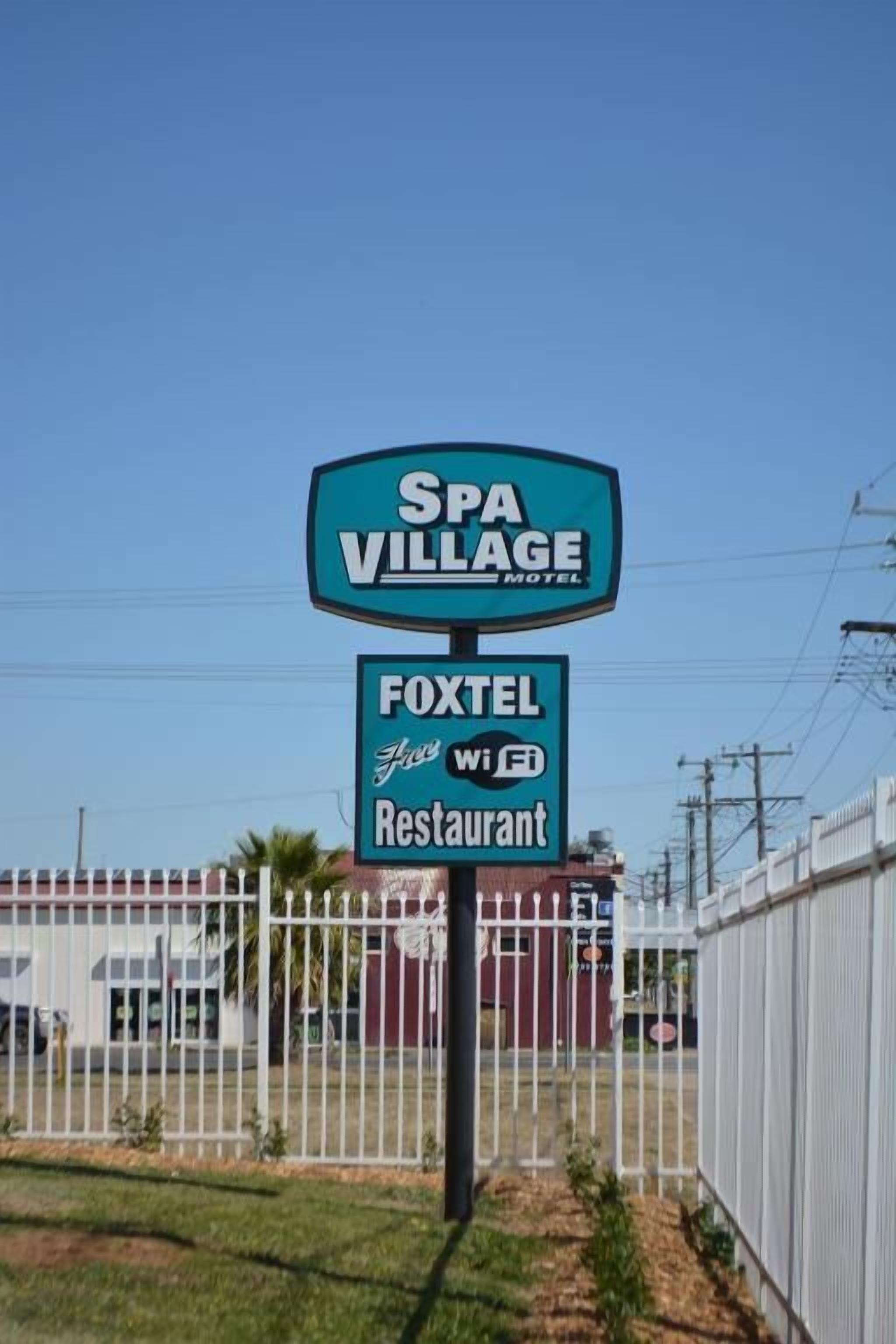 A sign for SPA VILLAGE MOTEL and FOXTEL for WiFi Restaurant.