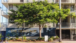 A multi-story building with balconies and a sign that reads "THE HERITAGE DARWIN". - The Heritage Darwin (Darwin)