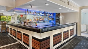 A bar area with a counter, shelves of bottles, and a menu sign. - Comfort Inn Grammar View (East Toowoomba)